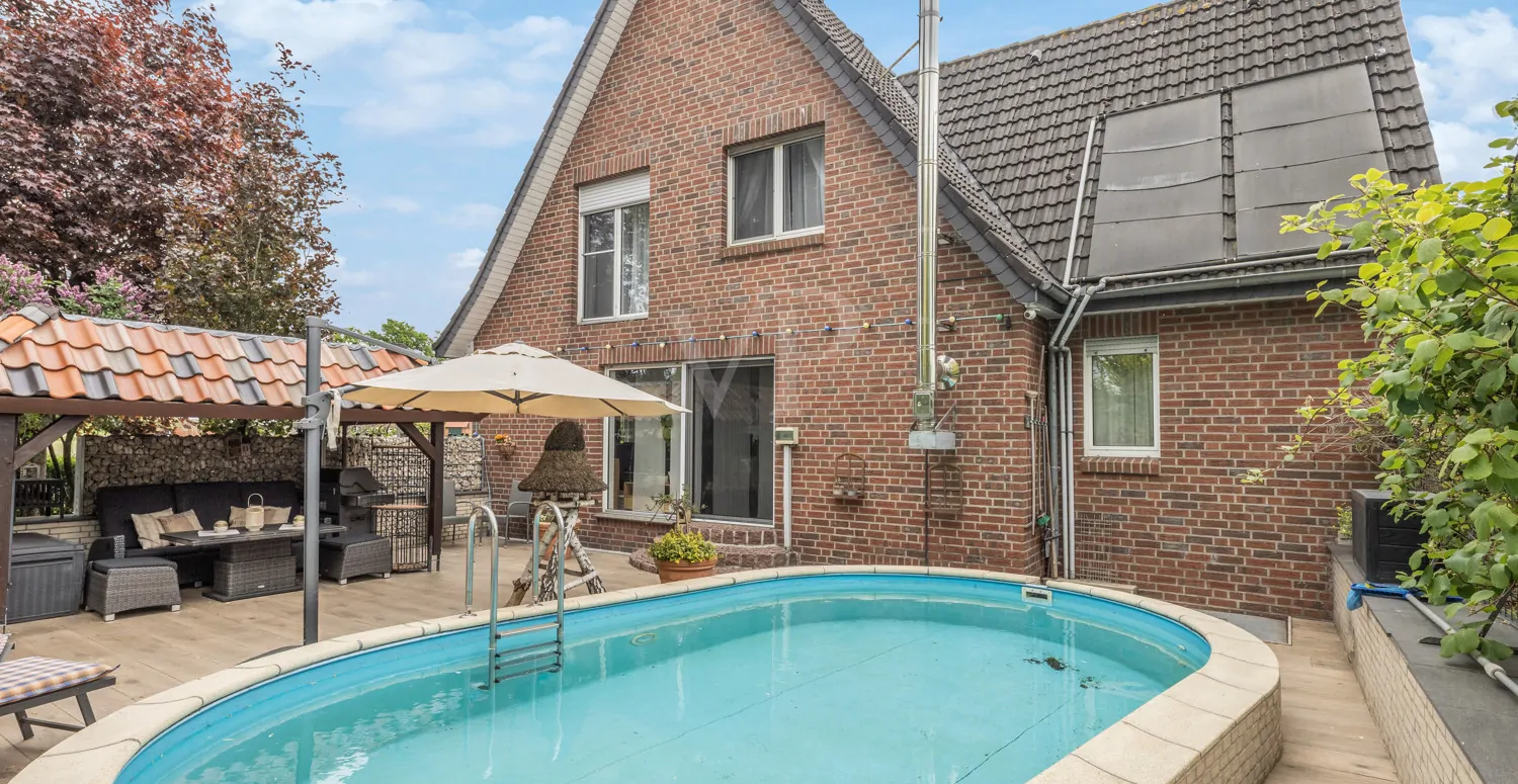 Rückansicht mit Terrasse und Poolanlage