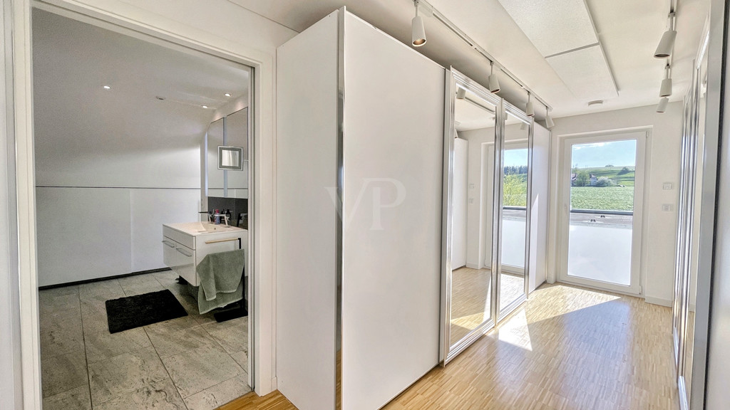 Ankleidezimmer mit Blick ins Bad im Neubau