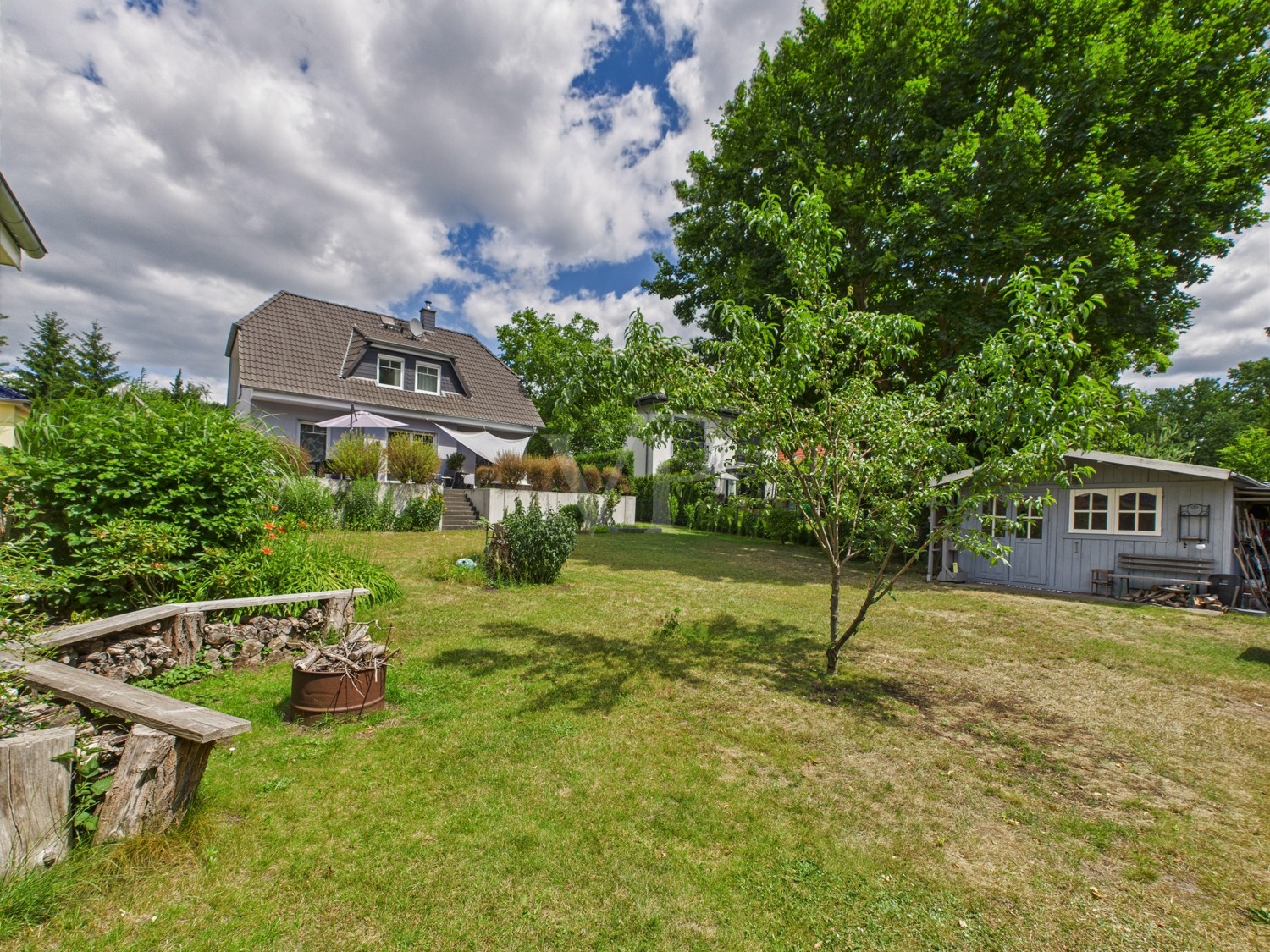 Sitzecke und Gartenhaus im Garten