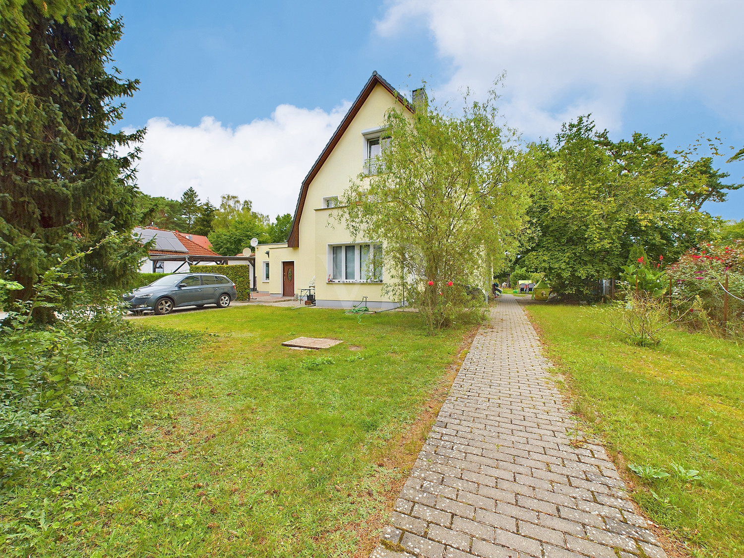 Hausansicht von vorne mit Blick in den Vorgarten