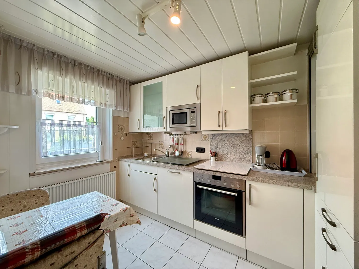 Immaculately maintained terraced house with extra plot of land including garage and outbuildings