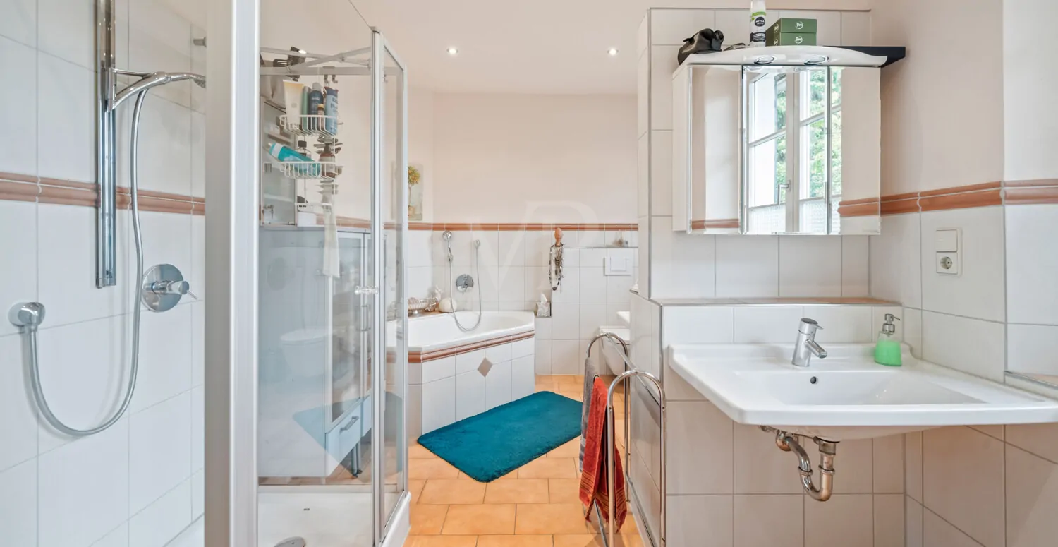 Badezimmer mit Badewanne, Dusche und zwei Waschbecken