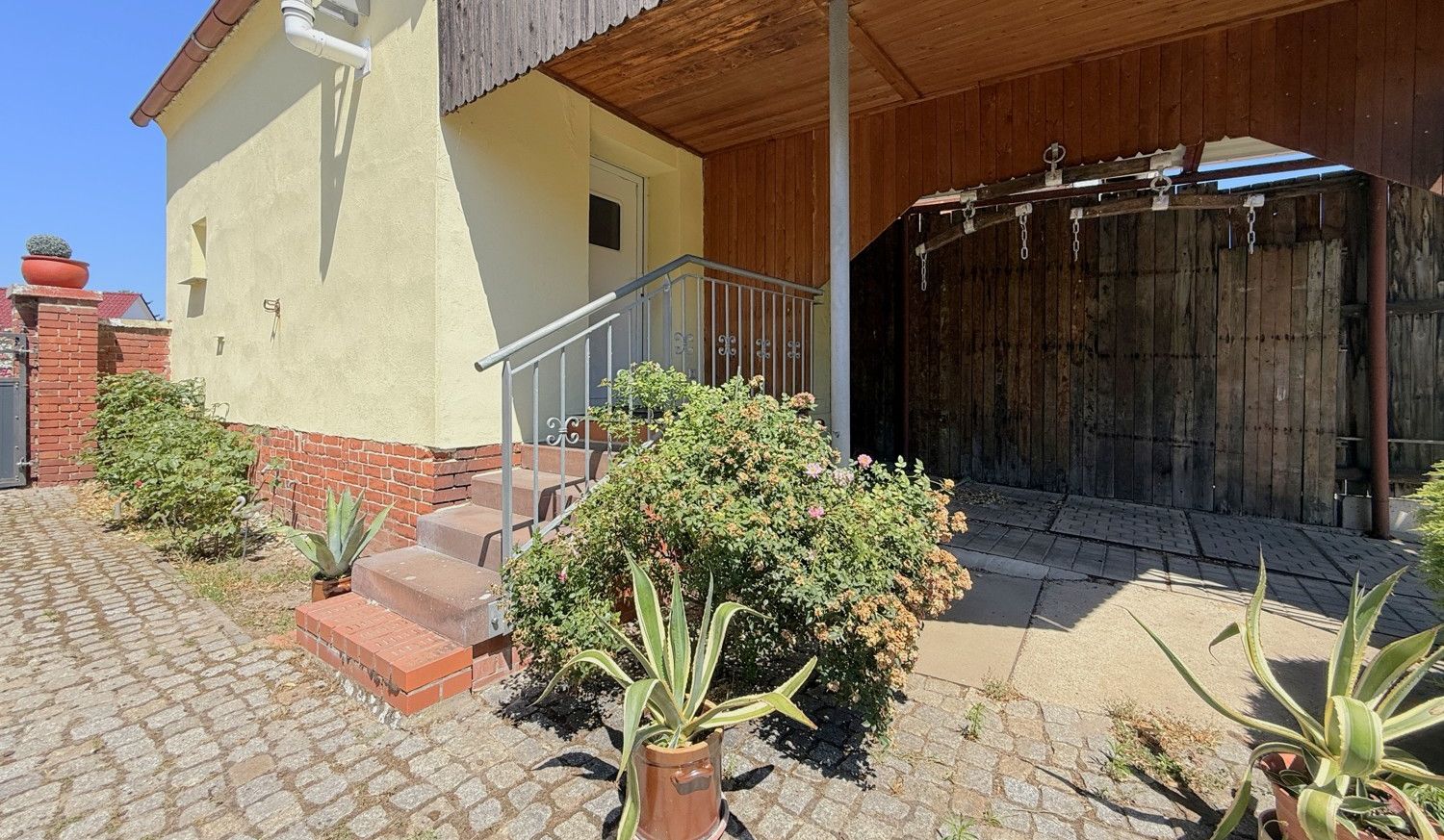Hauseingang vom Gästehaus mit Vordach und Carport